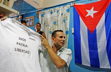 FILE PHOTO: Cuban dissident Jose Daniel Ferrer, holds up a t-shirt as he gives an interview to Reuters in his home at Palmarito de Cauto March 25, 2012. REUTERS/Mariana Bazo/File Photo