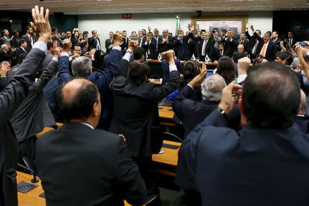 Congressman of the Brazilian Democratic Movement Party (PMDB) celebrate after announcing that they are withdrawing their support of President Dilma Rousseff's ruling coalition during their National Executive Meeting in Brasilia, Brazil, March 29, 2016. REUTERS/Adriano Machado