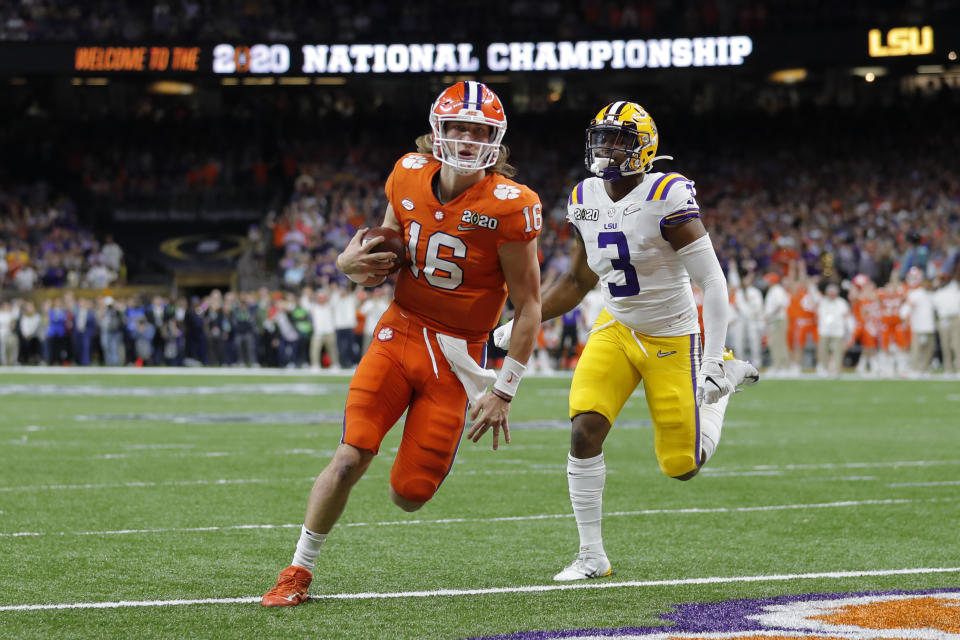 Clemson quarterback Trevor Lawrence scores past LSU safety JaCoby Stevens during the first half of a NCAA College Football Playoff national championship game Monday, Jan. 13, 2020, in New Orleans. (AP Photo/Gerald Herbert)