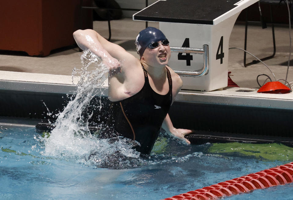 Yale's Iszac Henig reacts after winning the 50-yard freestyle final at the Ivy League women's swimming and diving championships at Harvard University, Thursday, Feb. 17, 2022, in Cambridge, Mass. Henig, who is transitioning to male but hasn't begun hormone treatments yet, is swimming for Yale's women's team. (AP Photo/Mary Schwalm)