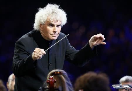 Conductor Simon Rattle takes part in the opening ceremony of the London 2012 Olympic Games at the Olympic Stadium July 27, 2012. REUTERS/Kai Pfaffenbach
