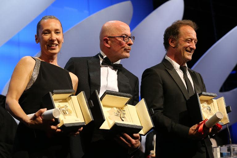 Emmanuelle Bercot (L), Jacques Audiard and Vincent Lindon pose on stage after they won the Best Actress, Palme d'Or and Best Actor award during the closing ceremony of the 68th Cannes Film Festival in Cannes, France, on May 24, 2015