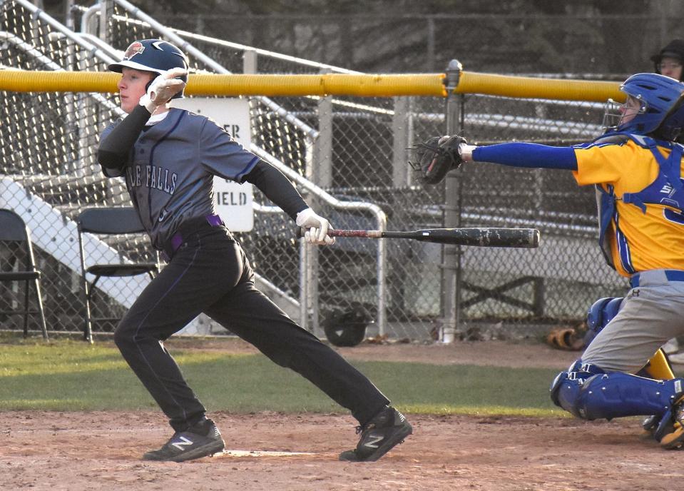 Sam Phillips follows through on his swing and delivers a two-run single for the Little Falls Mounties during the seven-run sixth inning of Wednesday's game against Mt. Markham.