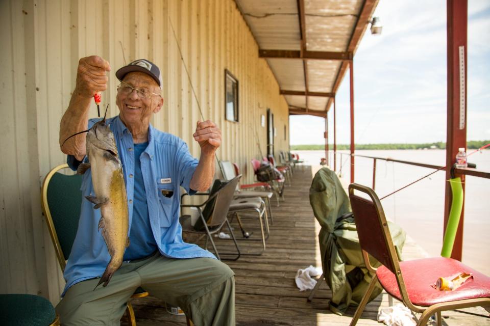 A fisherman shows off his catch at Lake Eufaula.