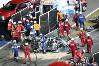 Ryan Newman, left, surrounded by rescue workers is moved to an ambulance after rescue workers removed him from his car after he was involved in a crash on NASCAR Daytona 500 auto race at Daytona International Speedway, Monday, Feb. 17, 2020, in Daytona Beach, Fla. Sunday's race was postponed because of rain. (AP Photo/David Graham)