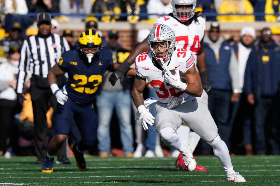 Nov 25, 2023; Ann Arbor, Michigan, USA; Ohio State Buckeyes running back TreVeyon Henderson (32) runs upfield during the NCAA football game against the Michigan Wolverines at Michigan Stadium.