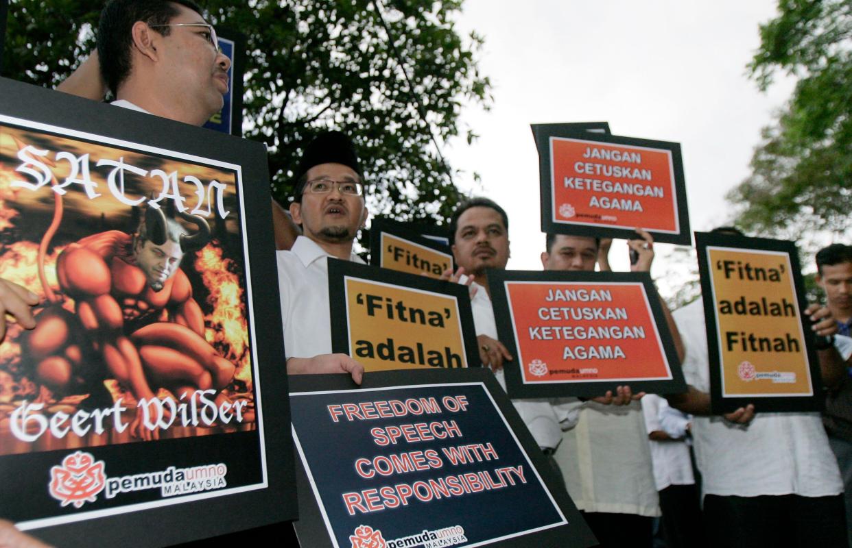 Malaysian ruling party members shout slogans during a protest outside the residence of the Dutch ambassador in Kuala Lumpur, Malaysia, Tuesday, April 1, 2008. Malaysia's religious council ruled late Monday that the movie, created by Dutch lawmaker Geert Wilders and titled 