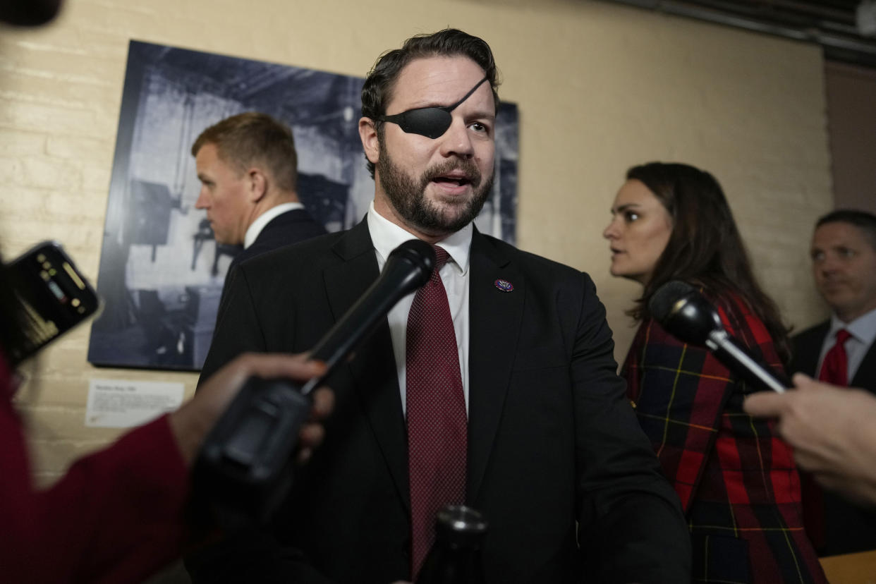 Dan Crenshaw speaks to media.