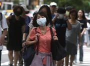 People wear face masks to protect against the spread of the coronavirus in Taipei, Taiwan, Saturday, June 6, 2020. (AP Photo/Chiang Ying-ying)