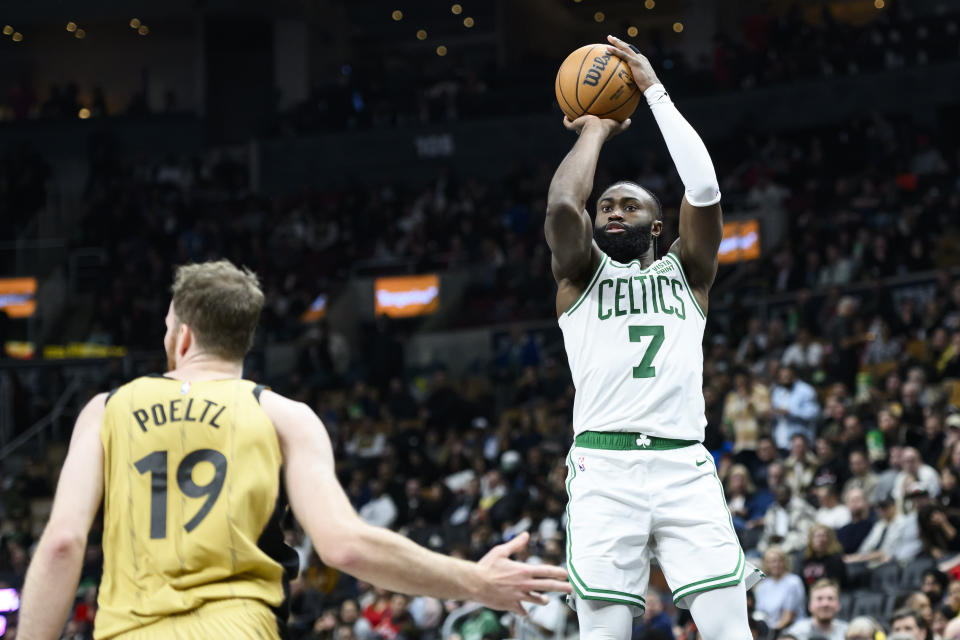 Boston Celtics guard Jaylen Brown (7) shoots over Toronto Raptors center Jakob Poeltl (19) during the second half of an NBA basketball game in Toronto on Friday, Nov. 17, 2023. (Christopher Katsarov/The Canadian Press via AP)