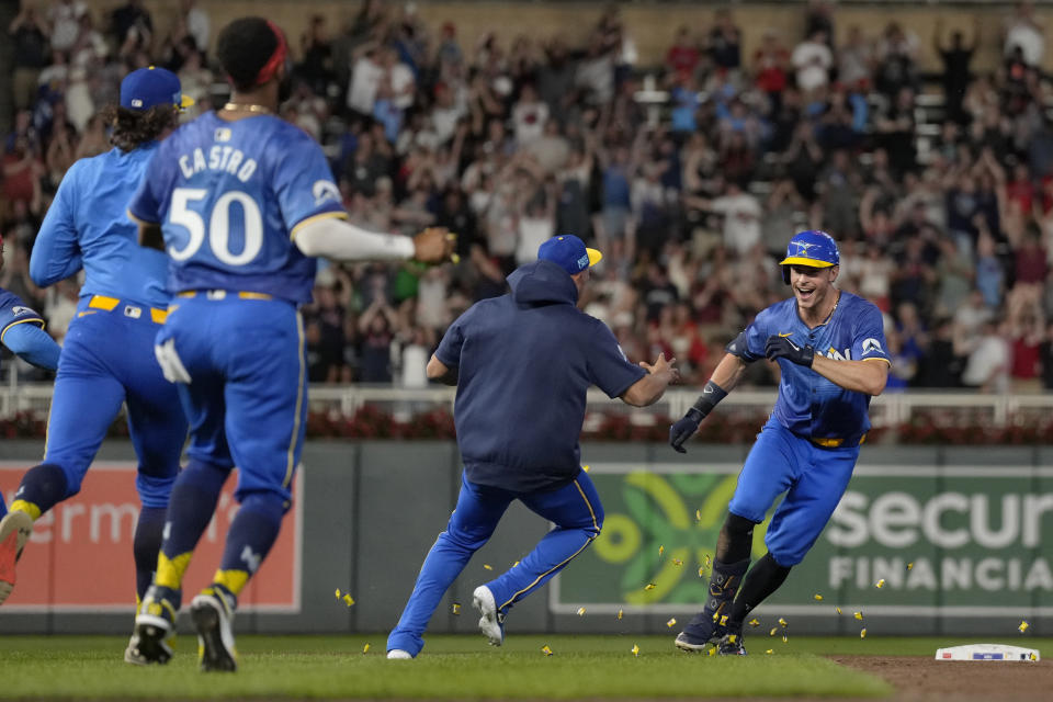 Minnesota Twins' Max Kepler, right, celebrates with teammates after he drove in the winning run against the Oakland Athletics during the 10th inning of a baseball game Friday, June 14, 2024, in Minneapolis. (AP Photo/Abbie Parr)