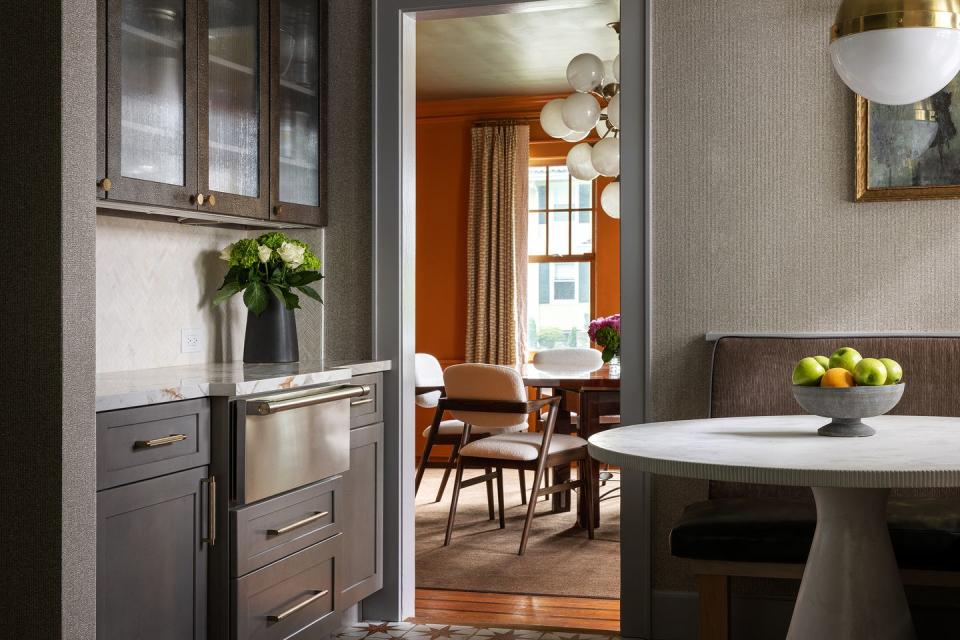 breakfast area in a kitchen next to the entryway looking into the dining room