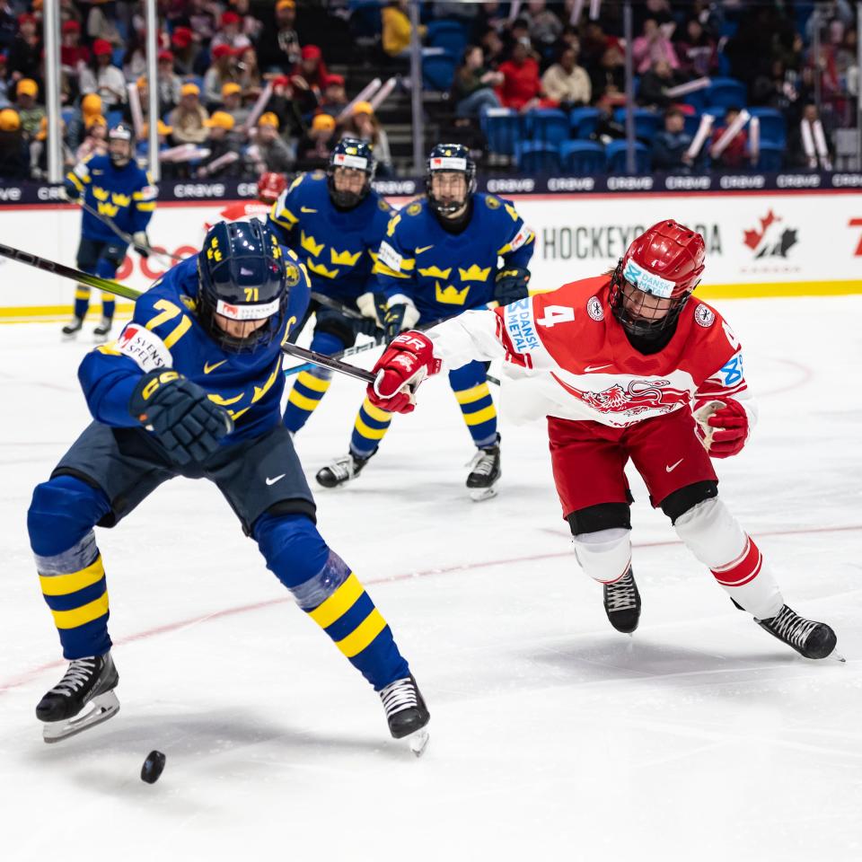 Sweden's Anna Kjellibin and Denmark's Silke Glude battle it out at the Adirondack Bank Center Wednesday during the opening game of the IIHF World Women's Championship.