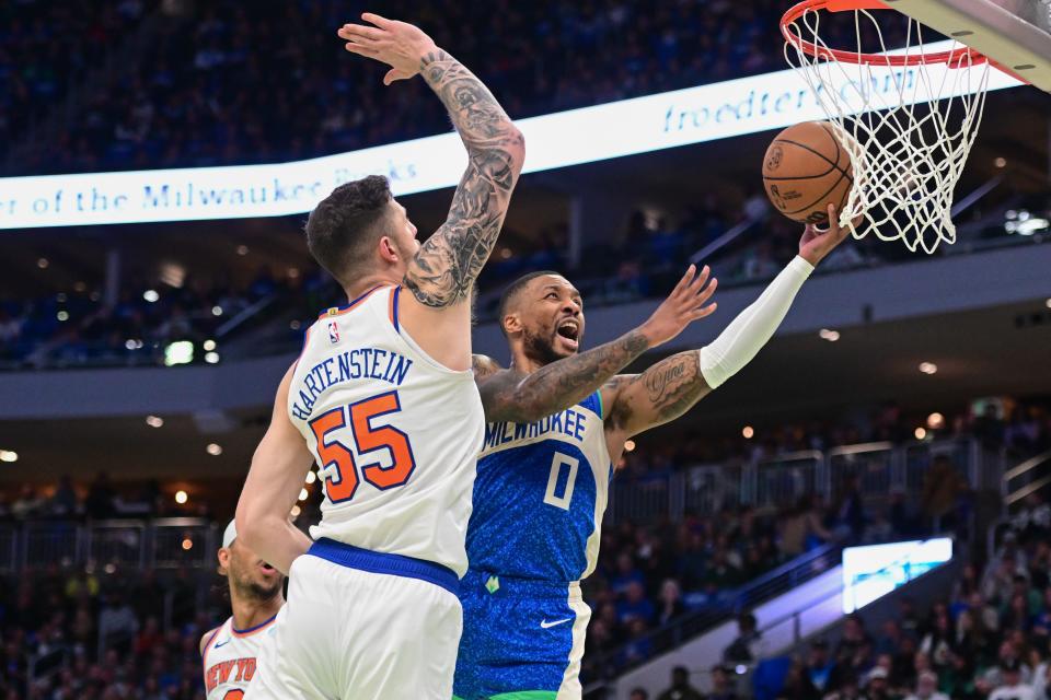Bucks guard Damian Lillard goes up for two of his team-high 30 points against Knicks center Isaiah Hartenstein in the second quarter Friday.