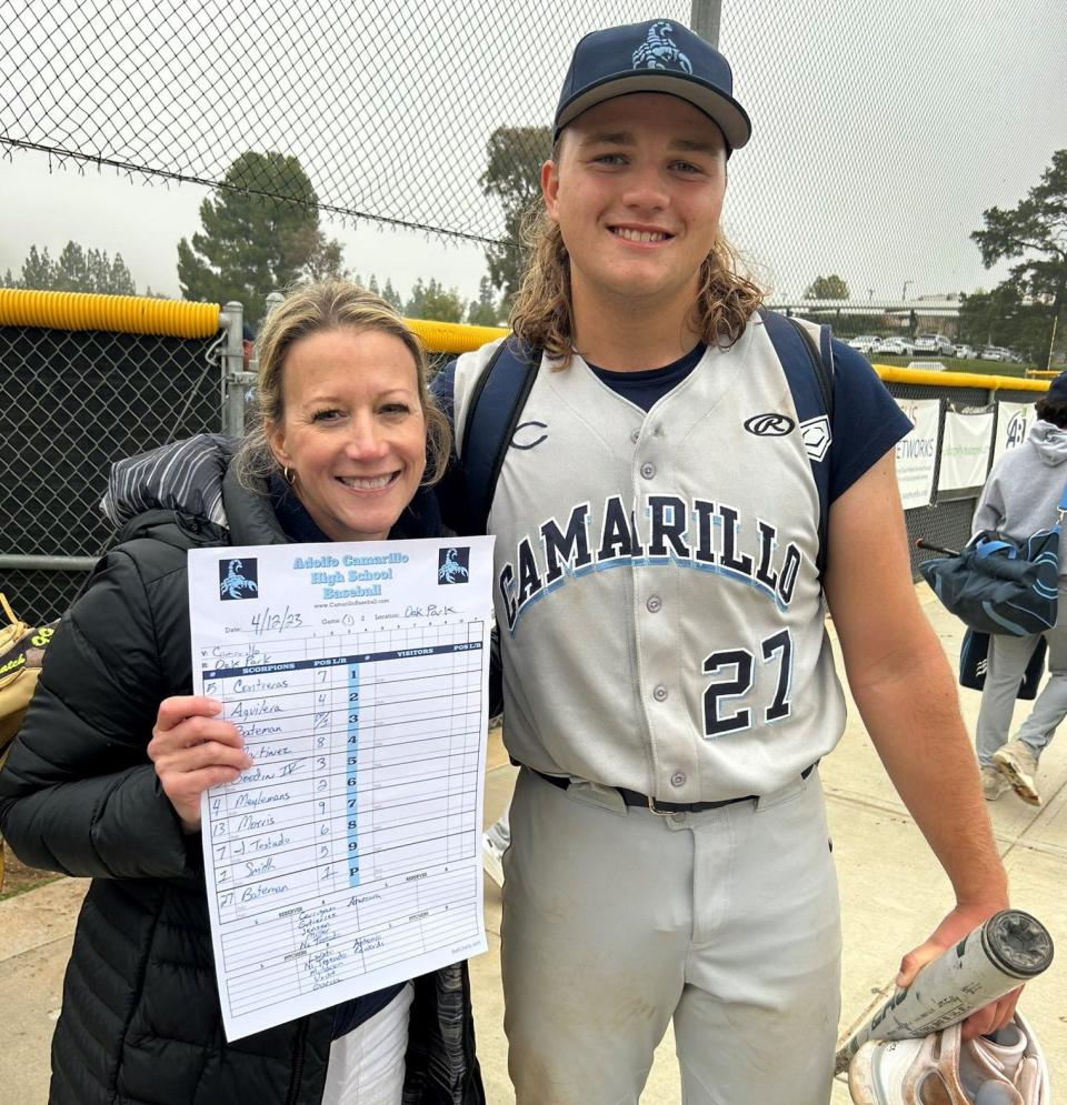 Camarillo High junior Boston Bateman poses with his mother, who holds the scoresheet after Bateman struck out 17 of the 21 batters he faced en route to a perfect game on the mound in the Scorpions' 11-0 win over Oak Park on Wednesday.