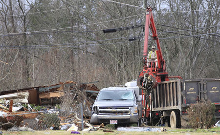 City crews clean up the damage caused by a tornado in a neighborhood in Birmingham, Alabama, December 26, 2015. REUTERS/Marvin Gentry