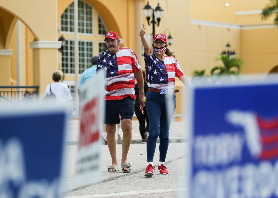 Skip Hickman (left) and Janet Brady, both of Port St. Lucie, Fla., exit precinct 11 after voting on Election Day at the Port St. Lucie Civic Center on Tuesday, Nov. 3, 2020, in Port St. Lucie.