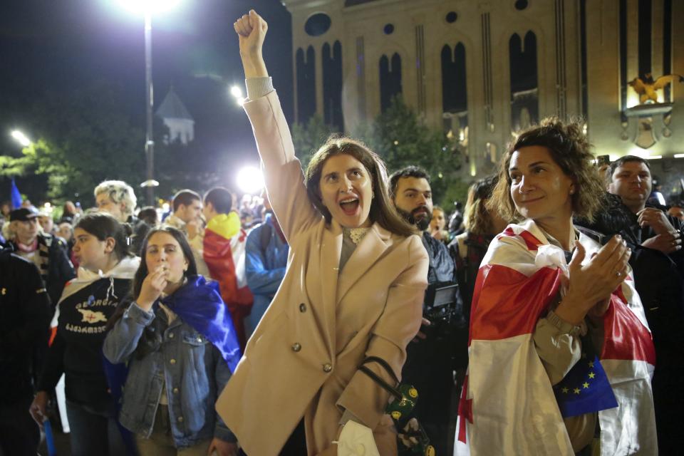 Demonstrators react as they listen to a speaker in front of the Parliament building during an opposition protest against "the Russian law" in the center of Tbilisi, Georgia, early Monday, May 13, 2024. Daily protests are continuing against a proposed bill that critics say would stifle media freedom and obstruct the country's bid to join the European Union. (AP Photo/Zurab Tsertsvadze)