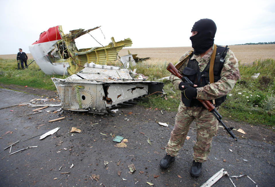 A pro-Russian separatist stands at the crash site of Malaysia Airlines flight MH17, near the village of Hrabove (Grabovo) in Donetsk region, Ukraine, July 18, 2014.  REUTERS/Maxim Zmeyev/File Photo