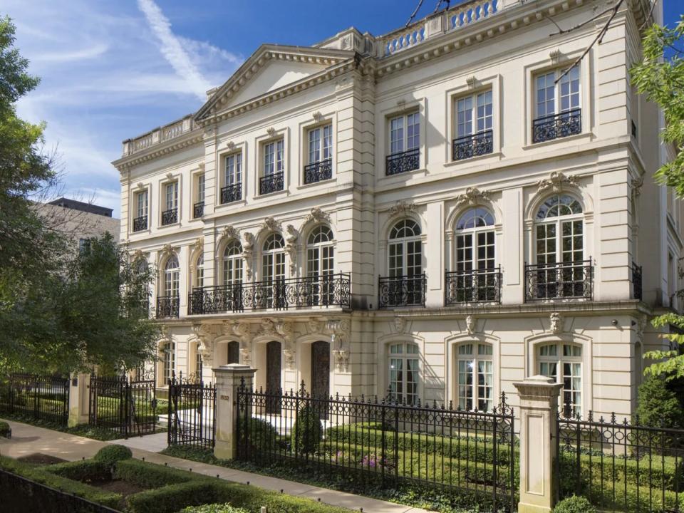 a gated three-story white home in Chicago, Illinois