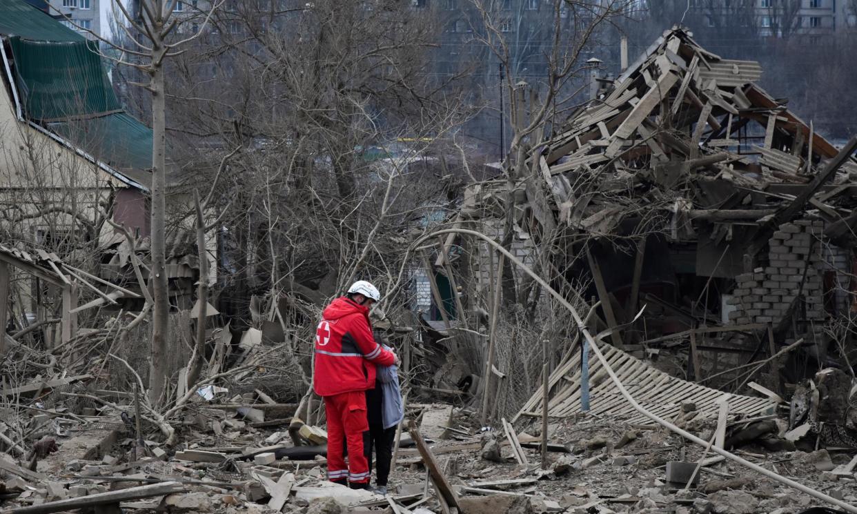 <span>A medical worker comforts a woman at the site of Russia’s air attack, in Zaporizhzhia, Ukraine, on Friday.</span><span>Photograph: Andriy Andriyenko/AP</span>