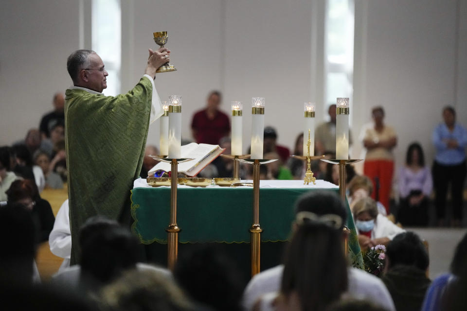 Rev. Silvio Baez, auxiliary bishop of Managua, Nicaragua, performs Mass at St. Agatha Catholic Church, which has become the spiritual home of the growing Nicaraguan diaspora, Sunday, Nov. 5, 2023, in Miami. For Baez, one of his concelebrant priests and many in the pews who have had to flee or were exiled from Nicaragua recently, the Sunday afternoon Mass at the Miami parish is not only a way to find solace in community, but also to keep pushing back against the Ortega regime's violent suppression of all critics, including many Catholic leaders. (AP Photo/Rebecca Blackwell)