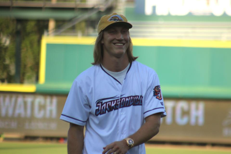 Jaguars quarterback Trevor Lawrence smiles after throwing out the ceremonial first pitch before the Jacksonville Jumbo Shrimp's Triple-A baseball home opener against Durham.