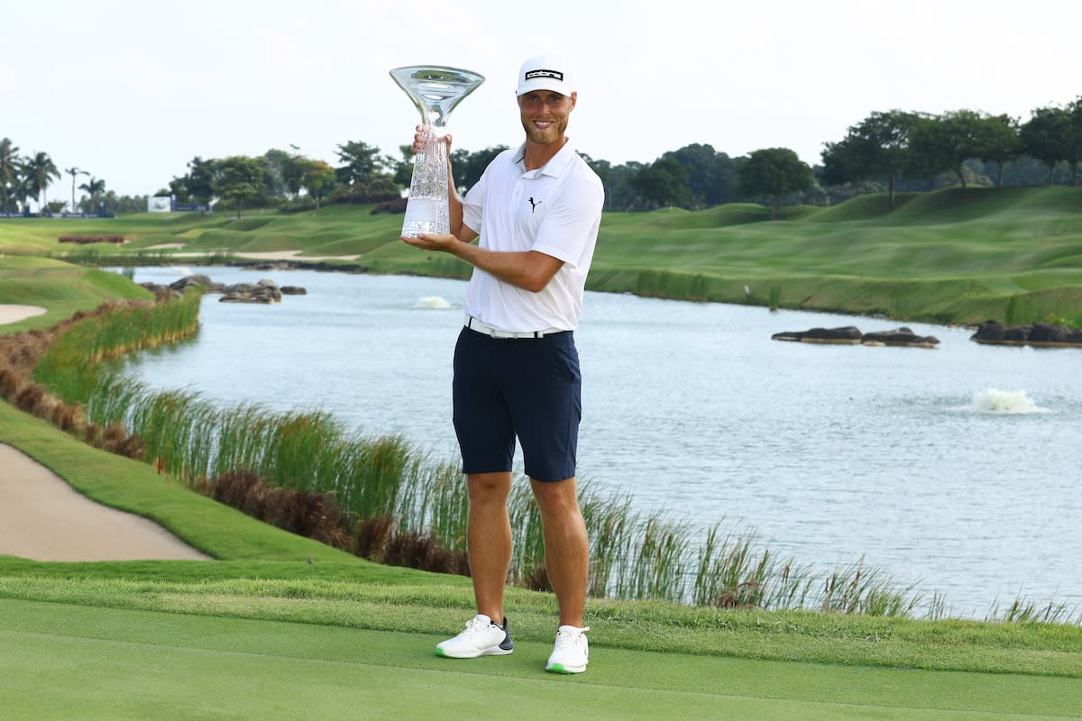 Jesper Svensson of Sweden poses with the trophy after winning the Porsche Singapore Classic. (PHOTO: Yong Teck Lim/Getty Images)