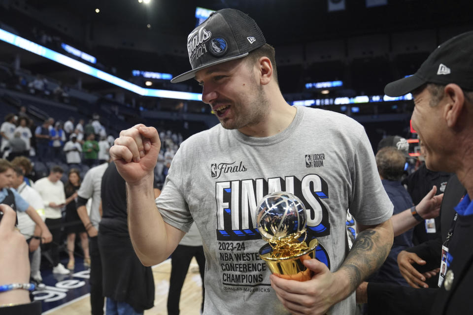 Dallas Mavericks guard Luka Doncic celebrates the team's win over the Minnesota Timberwolves in Game 5 of the Western Conference finals in the NBA basketball playoffs Thursday, May 30, 2024, in Minneapolis. The Mavericks won 124-103, taking the series 4-1 and moving on to the NBA Finals. (AP Photo/Abbie Parr)