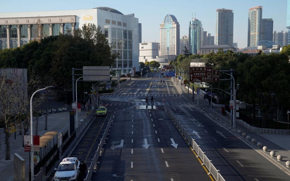 Fear of Covid has emptied streets and roads, such as this one in Lujiazui financial district, Shanghai - Aly Song/Reuters