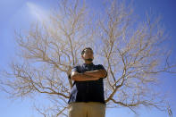 Benito Luna-Herrera, a 7th-grade social studies teacher at California City Middle School, poses for a photo outside the California City Middle School in California City, Calif., on Friday, March 11, 2022. Since the pandemic started, experts have warned of a mental health crisis facing American children that is now visibly playing out at schools across the country. (AP Photo/Damian Dovarganes)