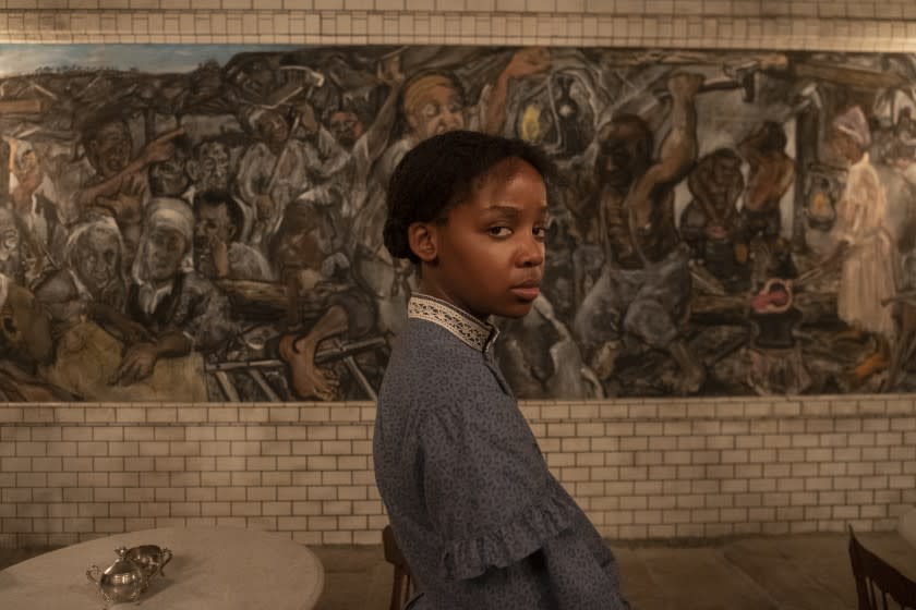 Thuso Mbedu standing in front of a mural in "The Underground Railroad"