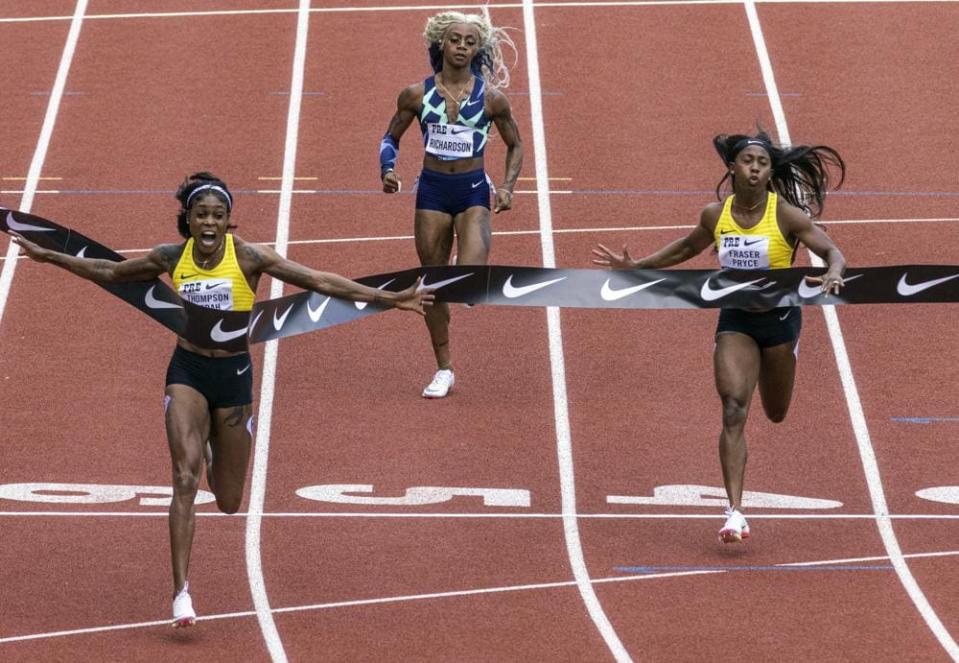 Jamaica’s Elaine Thompson-Herah, left, wins the 100 meters, as American track and field sprinter Sha’carri Richardson, center, also competes, Saturday, Aug. 21, 2021, at the Prefontaine Classic track and field meet in Eugene, Ore. (AP Photo/Thomas Boyd)
