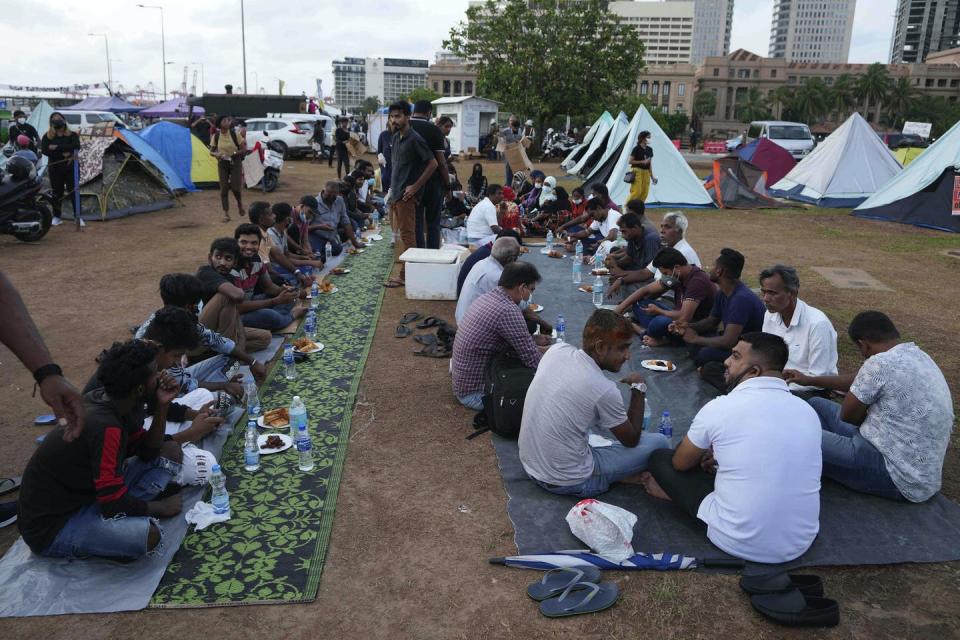 <span class="caption">Sri Lankan Muslims wait to break the Ramadan fast at a protest site outside the president’s office in Colombo, Sri Lanka, on April 20, 2022.</span> <span class="attribution"><a class="link " href="https://newsroom.ap.org/detail/SriLankaEconomicCrisis/15fa249db25d465ba1710c09c1f1c7e8/photo?Query=sri%20lanka%20muslim&mediaType=photo&sortBy=arrivaldatetime:desc&dateRange=Anytime&totalCount=954&currentItemNo=0" rel="nofollow noopener" target="_blank" data-ylk="slk:AP Photo/Eranga Jayawardena;elm:context_link;itc:0;sec:content-canvas">AP Photo/Eranga Jayawardena</a></span>