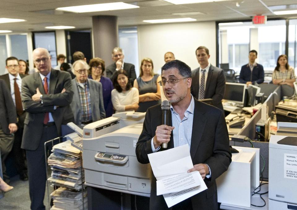 After the Pulitzer Prize for Public Service was awarded to The Washington Post, reporters and editors gather in the newsroom in Washington Monday, April 14, 2014, as contributing writer Barton Gellman describes the effort that went into a series of stories on the government’s massive surveillance program based on information leaked by National Security Agency employee Edward Snowden. The disclosures showed that the NSA has collected information about millions of Americans’ phone calls and emails based on its classified interpretations of laws passed after the 2001 terrorist attacks. The Pulitzer Prizes, journalism’s highest honor, are given out each year by Columbia University on the recommendation of a board of journalists and others. This is Gellman’s third Pulitzer honor. (AP Photo/J. Scott Applewhite)