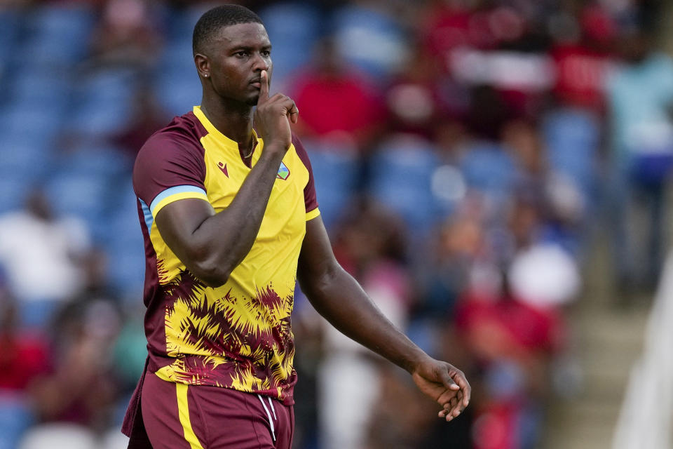 West Indies' Jason Holder celebrates the dismissal of England's captain Jos Buttler during the fourth T20 cricket match at Brian Lara Stadium in Tarouba, Trinidad and Tobago, Tuesday, Dec. 19, 2023. (AP Photo/Ricardo Mazalan)