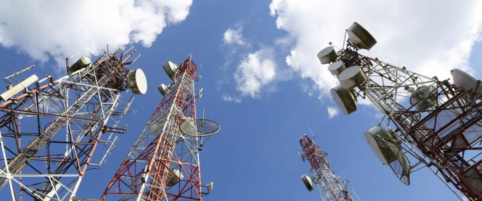 Telecommunication tower with blue sky and cloud