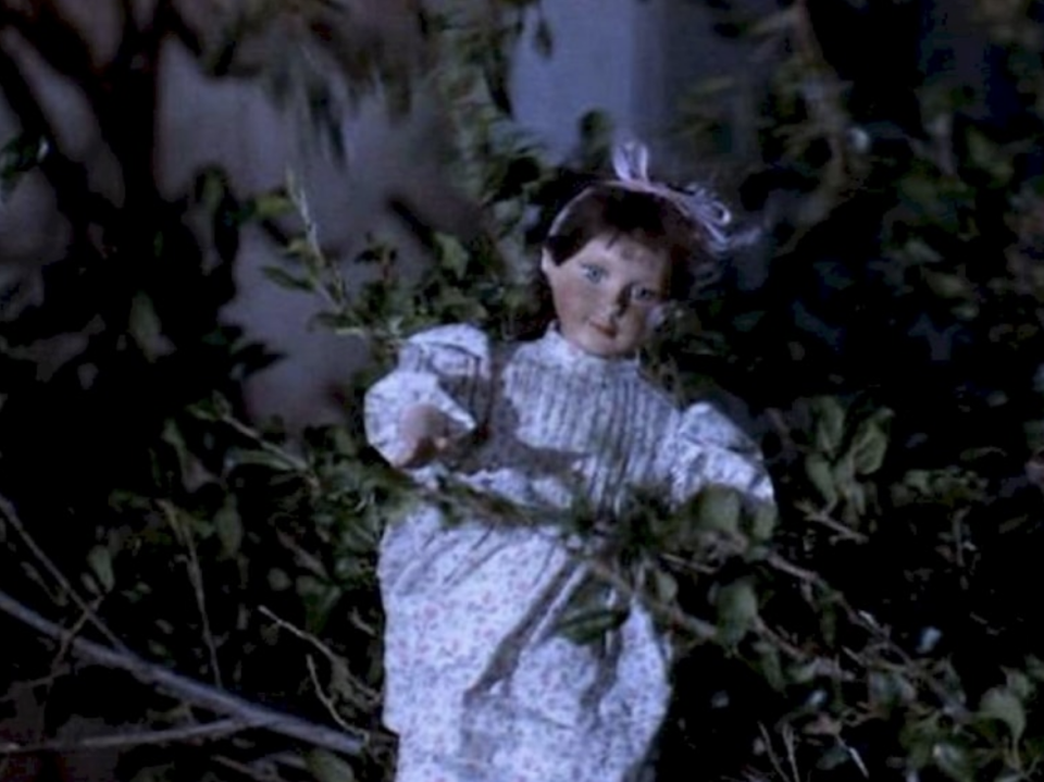 Miss Honey's doll amid tree branches