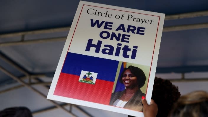 An attendee holds a sign at a July 16th vigil in Miami for Haitian First Lady Martine Moise at Jackson Memorial Hospital. Haiti’s first lady was treated there after she was shot during an attack at her home in Haiti where her husband, President Jovenel Moïse, was assassinated. (Photo by Joe Raedle/Getty Images)