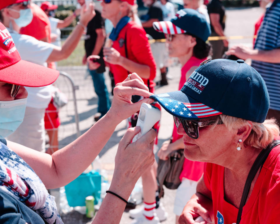 Attendees get their temperatures taken before a campaign rally. 