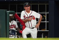 Atlanta Braves manager Brian Snitker watches from the dugout during the team's baseball game against the New York Mets on Monday, Aug. 15, 2022, in Atlanta. (AP Photo/John Bazemore)