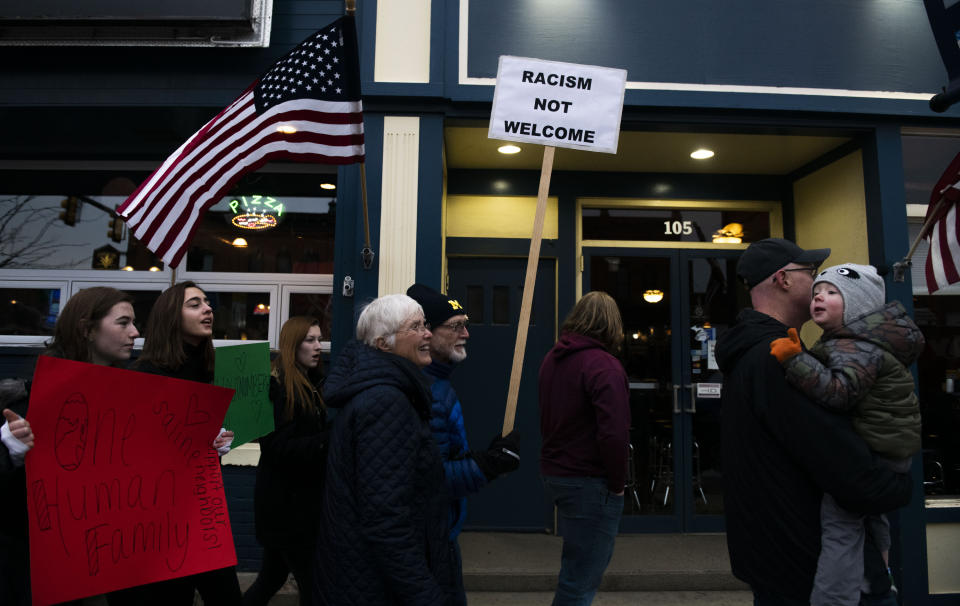 Rally participants walk the streets during the Saline Diversity Inclusion Rally, Wednesday Feb. 5, 2020, in downtown Saline, Mich. People gathered to promote unity and inclusion in the wake of a school meeting when a white parent asked a Hispanic parent why he didn't “stay in Mexico.” (Nicole Hester/Ann Arbor News via AP)