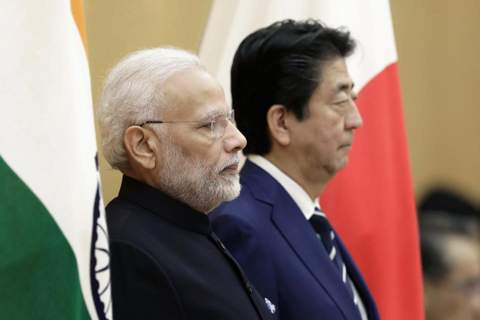 Japan's Prime Minister Shinzo Abe, right, and India's Prime Minister Narendra Modi observe an honor guard ahead of a meeting at Abe's official residence in Tokyo Monday, Oct. 29, 2018. (Kiyoshi Ota/Pool Photo via AP)