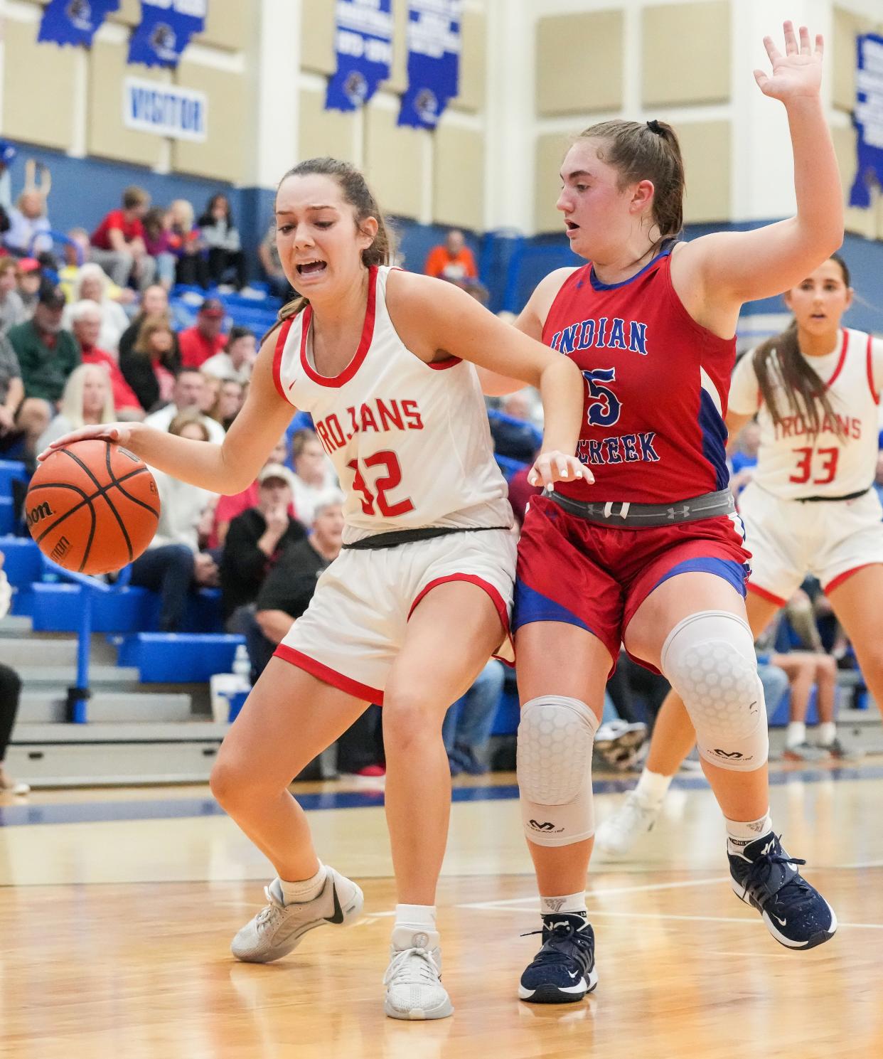 Center Grove Trojans Lilly Bischoff (32) rushes up the court against Indian Creek Lauren Foster (5) on Thursday, Nov. 16, 2023, during the semifinals of the Johnson County Tournament at Franklin Community High School in Franklin. The Center Grove Trojans defeated Indian Creek, 61-52.