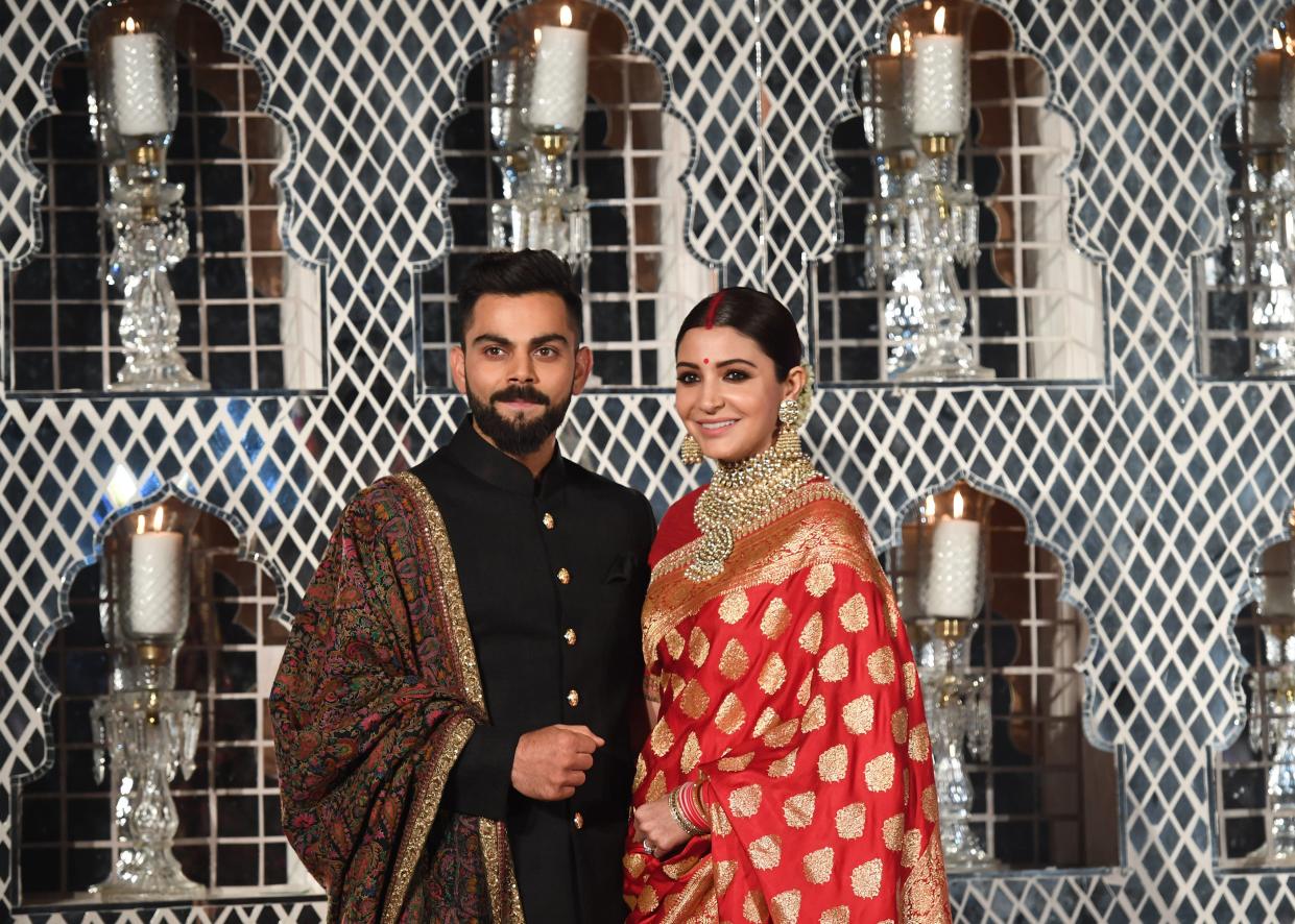 <p>Virat Kohli and Anushka Sharma at their wedding reception in New Delhi in 2017</p> (Getty Images)