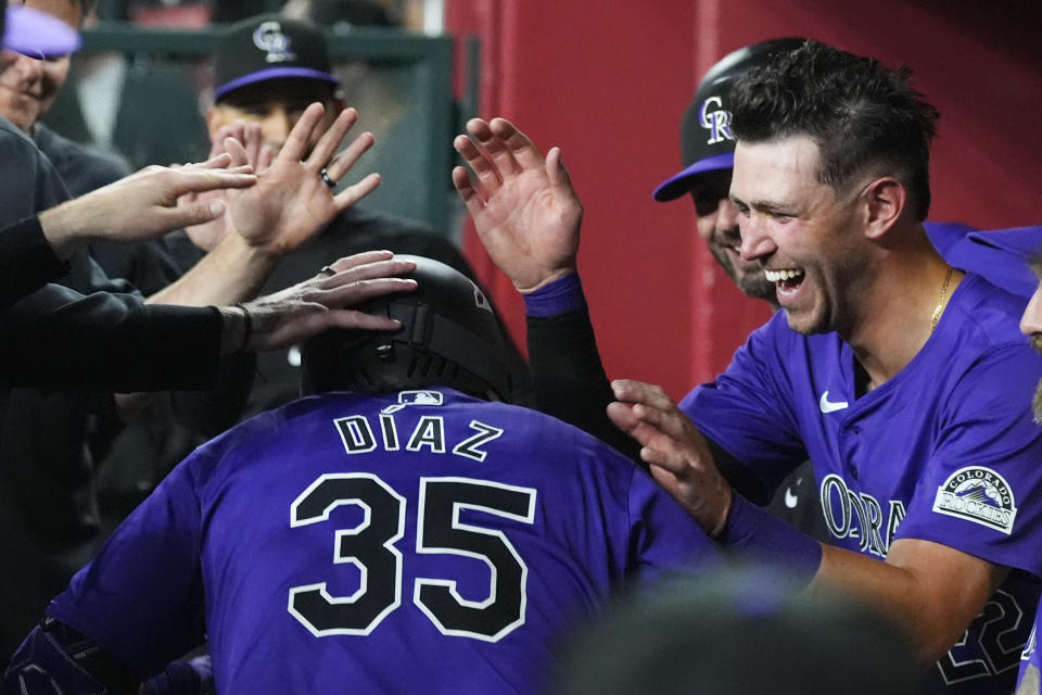 Colorado Rockies' Elias Diaz (35) celebrates his home run against the Arizona Diamondbacks with teammates, including Rockies' Nolan Jones, right, during the second inning of a baseball game Friday, March 29, 2024, in Phoenix. (AP Photo/Ross D. Franklin)