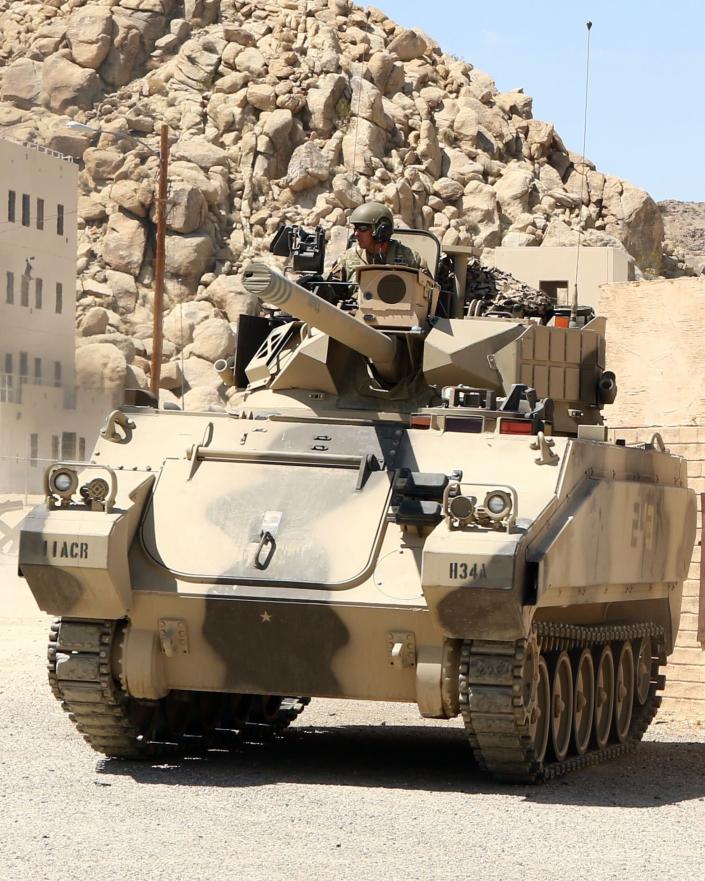 An Army soldier from 11th Armored Cavalry Regiment spots enemy forces from the top of an Opposing Force Surrogate Vehicle during a demonstration of military capabilities Sept. 3 in Razish at the National Training Center on Fort Irwin, Calif. (Staff Sgt. Elizabeth O. Bryson/Army)