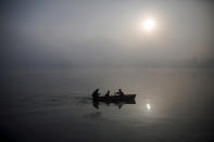 <p>North Korean military personnel paddle a small boat amid morning fog over Taedong River in Pyongyang, Oct. 8, 2015. (Damir Sagolj/Reuters) </p>