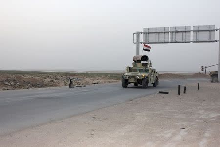 A convoy of Iraqi security forces drives on a road during a patrol in the Hamrin mountains in Diyala province July 25, 2014. Picture taken July 25, 2014. REUTERS/Stringer