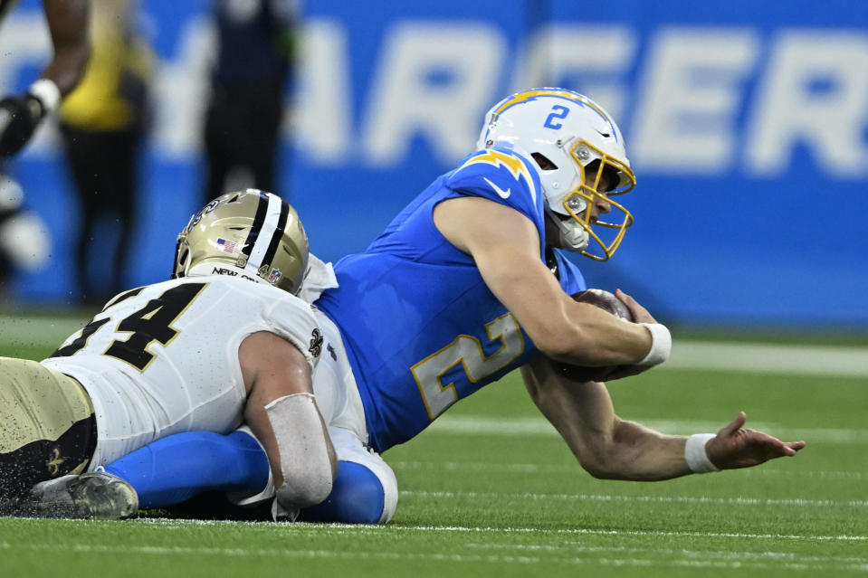 New Orleans Saints defensive end Niko Lalos sacks Los Angeles Chargers quarterback Easton Stick (2) on fourth down in the second half of an NFL football game in Inglewood, Calif., Sunday, Aug. 20, 2023. (AP Photo/Alex Gallardo)